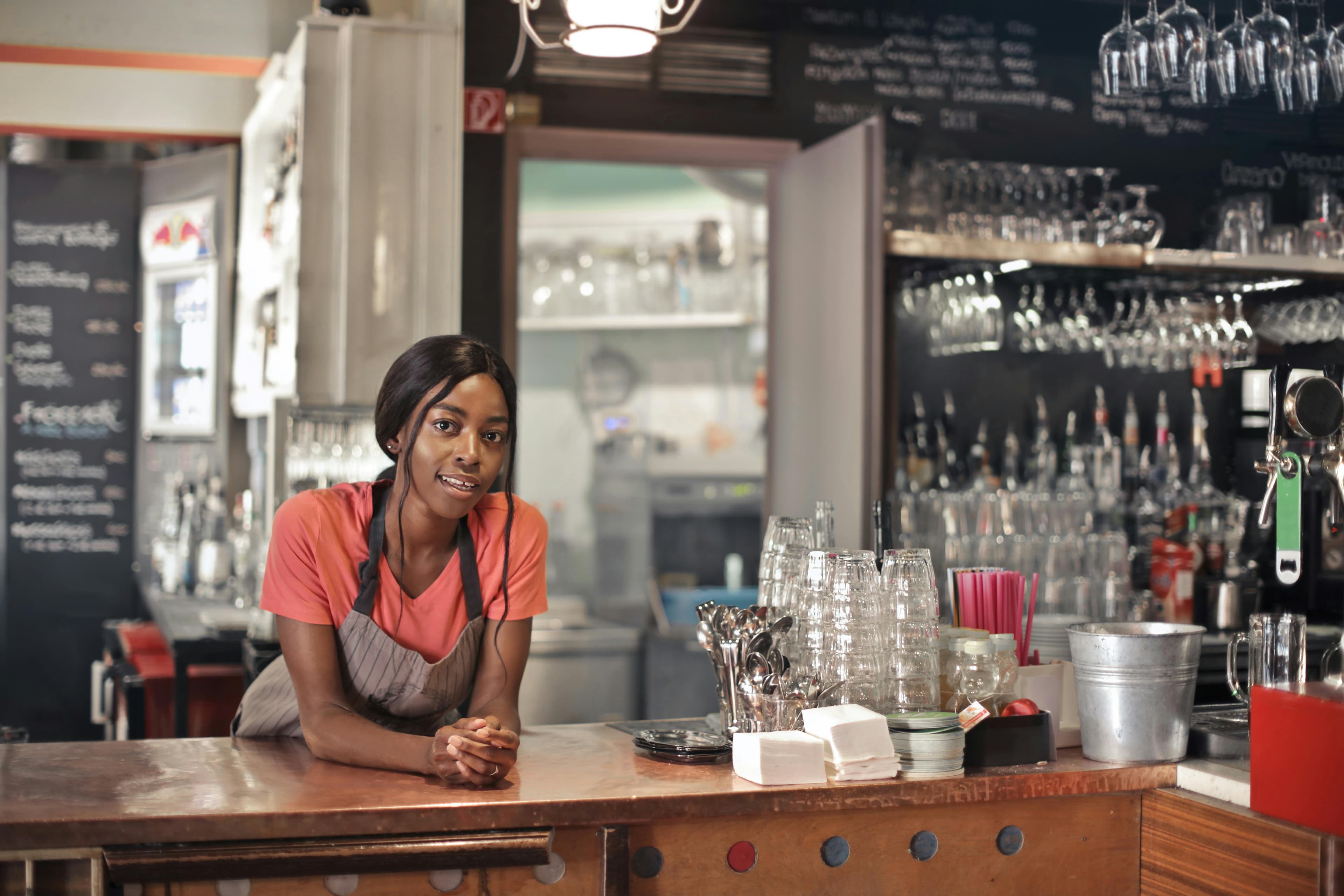 Restaurant counter with staff serving customers.